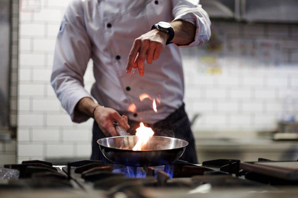 Chef Cooking Deep Fryers In A Kitchen