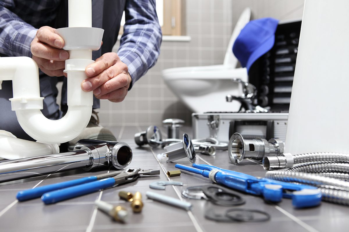 Plumber At Work Installing A Bathroom