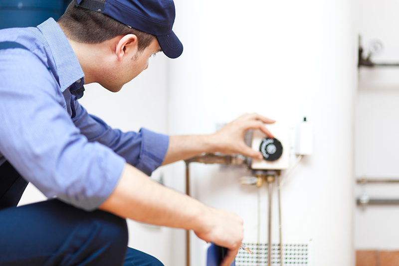 Plumber Repairing Hot Water Heater